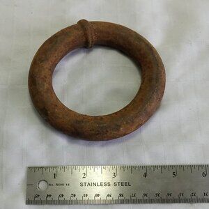 Vintage ring made of rusted iron metal that could be a mooring ring.